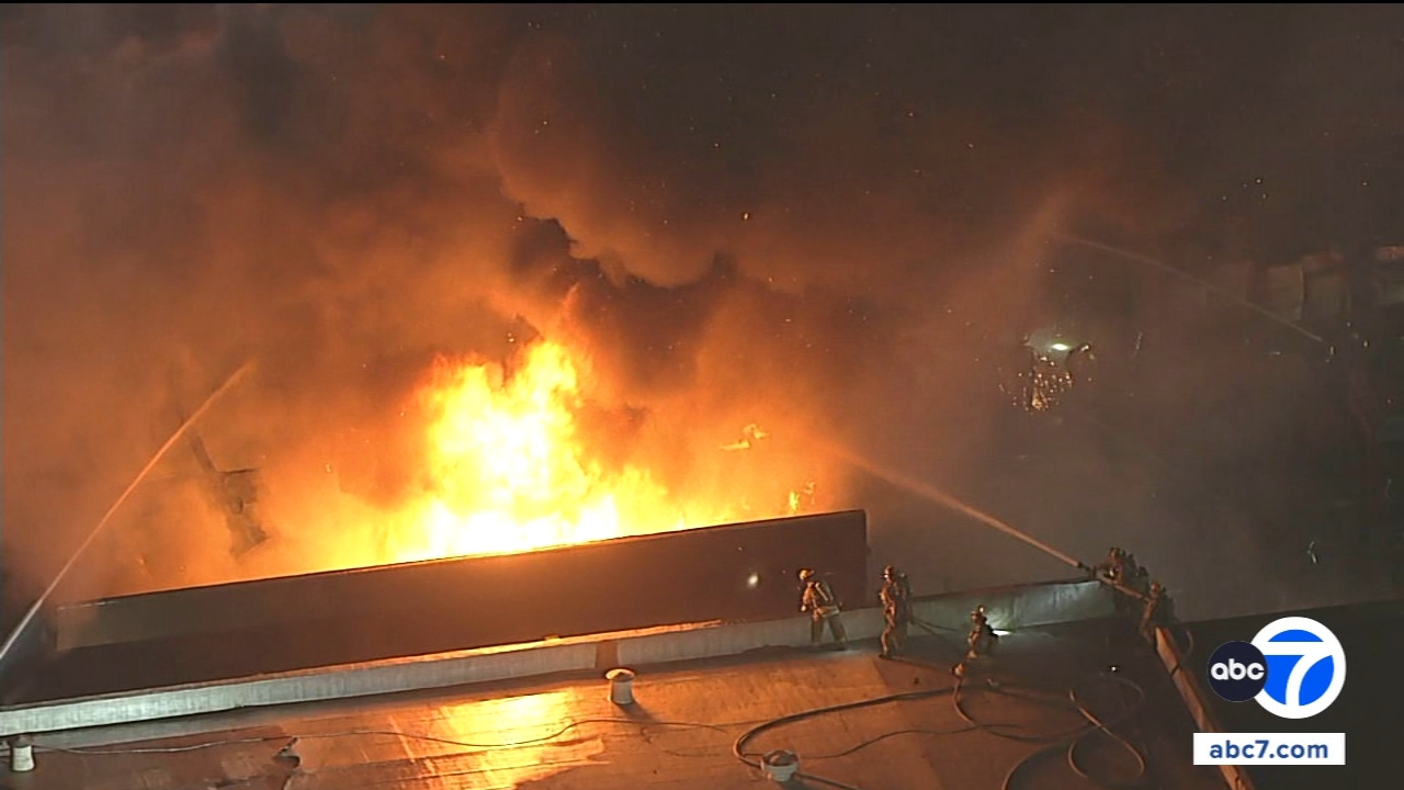 Large fire erupts at business in Harbor Gateway, filling the air with black smoke