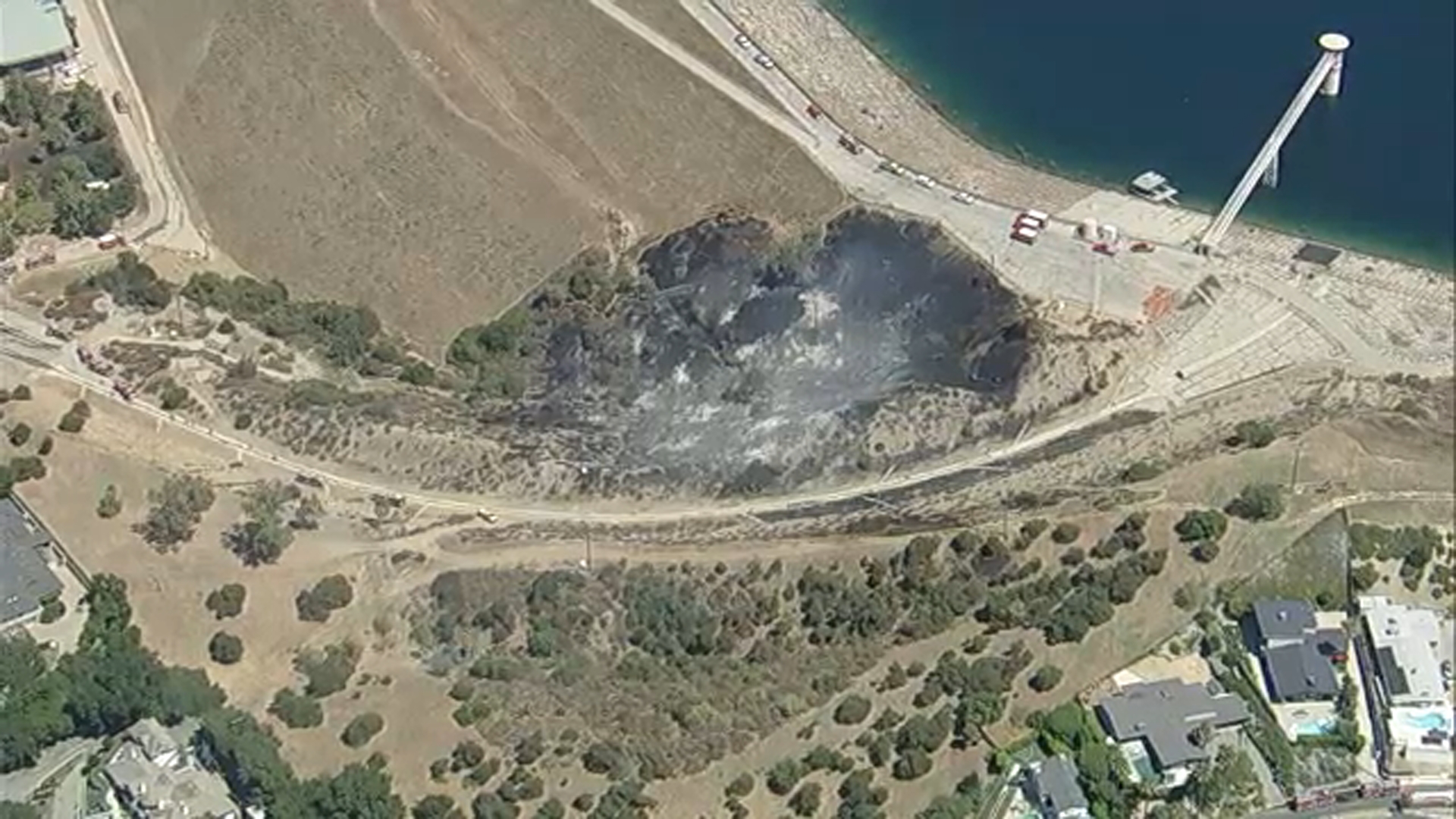 Evacuation warning issued due to brush fire near Encino Reservoir; water drops halt flames' progress